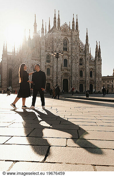 Romantic photo of lovers on the main square of Milan  backlight