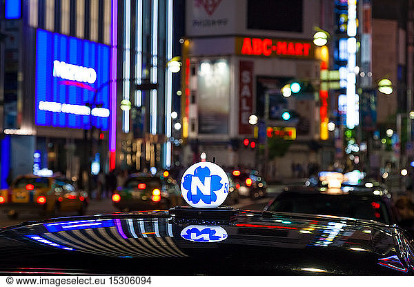 Roof of taxi and neon advertising signs at night in Shinjuku District  Tokyo  Japan.