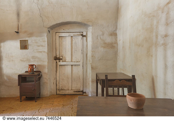 Room in an adobe building with furnishings  at Mission La Purisima State Historic Park  Lompoc  California  Founded in 1787  the eleventh mission of the twenty-one Spanish Missions established in California