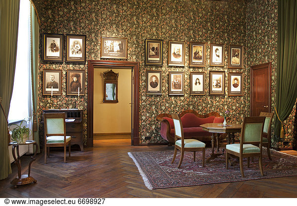 Room With Framed Portraits