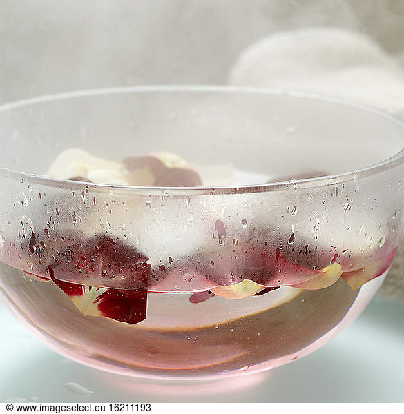Rose petals in bowl with hot water