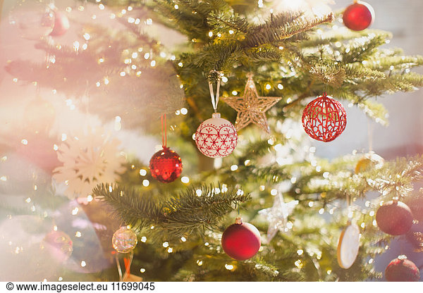 Rot-weiß-goldene Ornamente und Stern am Weihnachtsbaum