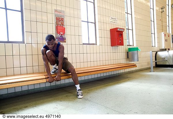 Rotterdam  Netherlands. An athlete and marathon runner stretching his legs and muscles after a training run through Maastunnel.