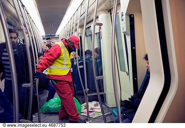 Rotterdam  Netherlands. Middle aged subway employee  cleaning up left dirt of subway passengers.