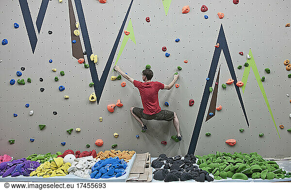 rout setter trying new bouldering problems at indoor climbing wall