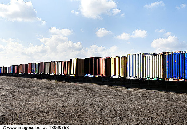 Row of cargo containers against sky