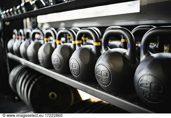 Row of kettlebells on gym rack