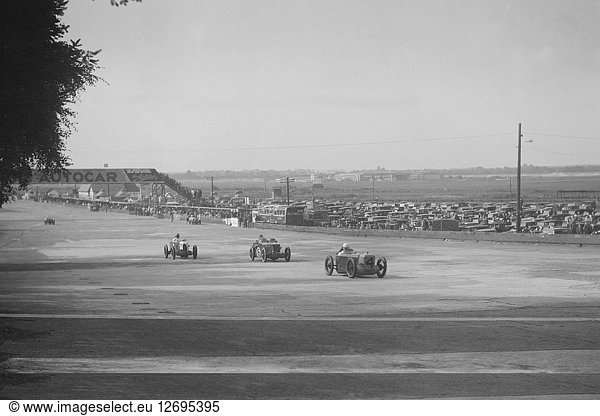 Rubber Duck  Austin 7 von LP Driscoll  vor zwei MG C  BRDC 500-Meilen-Rennen  Brooklands  1931. Künstler: Bill Brunell.