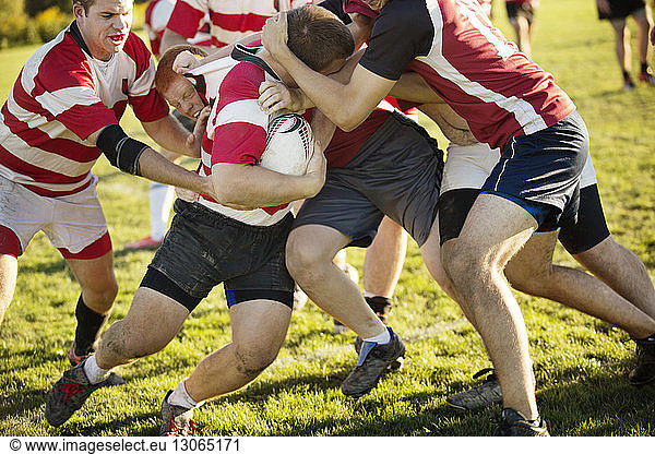 Rugby players practicing on field