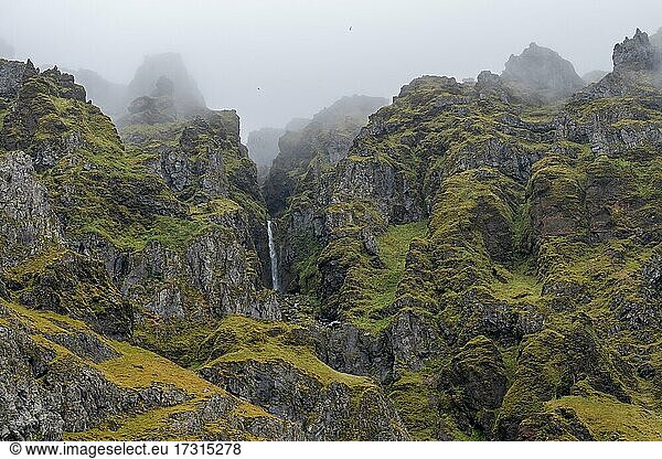 Rugged mountainsides and waterfall  near Skógar or Skogar  Sudurland  South Iceland  Iceland  Europe