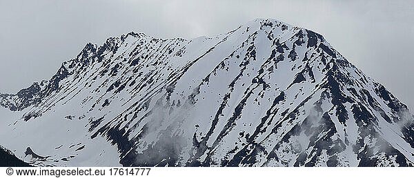 Rugged peak of Hudson Bay Mountain covered in snow; Smithers  British Columbia  Canada