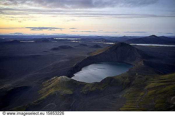 Ruhiger See in vulkanischem Gelände am Abend