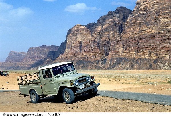 Run down four wheel drive parked in the desert Wadi Rum Jordan