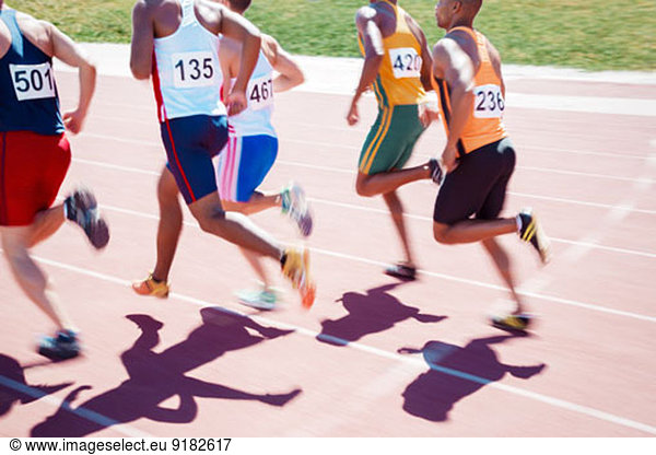 Runners racing on track
