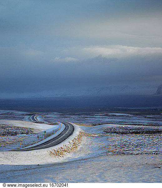 Rural road through snowy terrain in Iceland