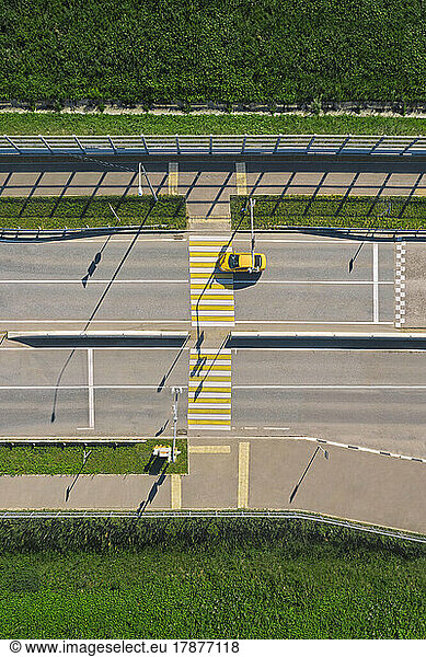 Russia  Aerial view of single car passing empty zebra crossing