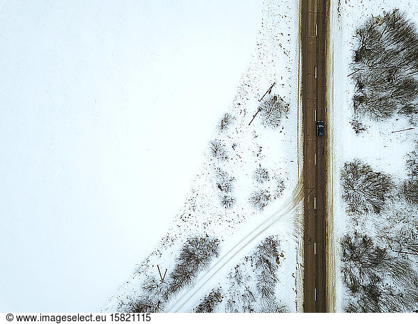 Russia  Moscow Oblast  Aerial view of countryside highway cutting through snow-covered landscape