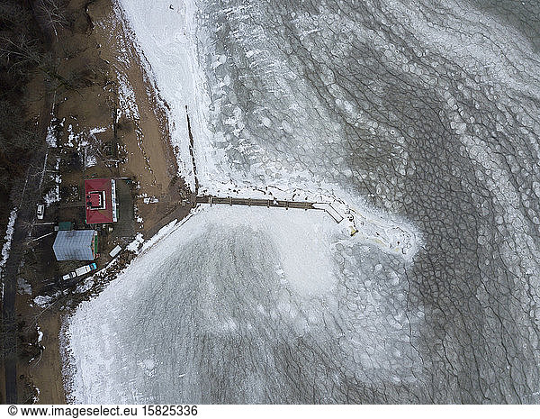 Russia  Saint Petersburg  Sestroretsk  Aerial view of secluded houses and pier on frozen shore of Gulf of Finland