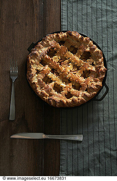 Rustic homemade apple pie in a cast iron pan