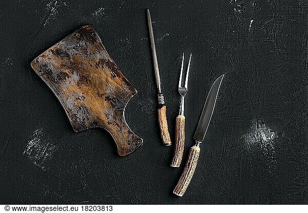 Rustic shabby cutting board with knife and fork for steak and knife sharpener