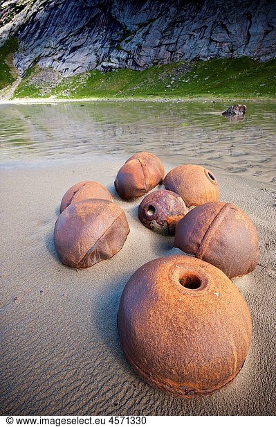 Rusting metal bouys on Bunes beach  Lofoten islands  Norway