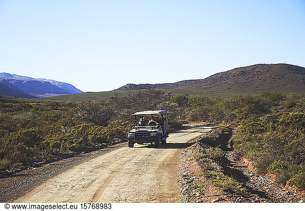 Safari off-road vehicle on sunny emote dirt road South Africa