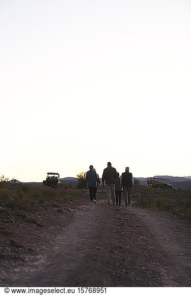 Safari tour group walking along dirt road