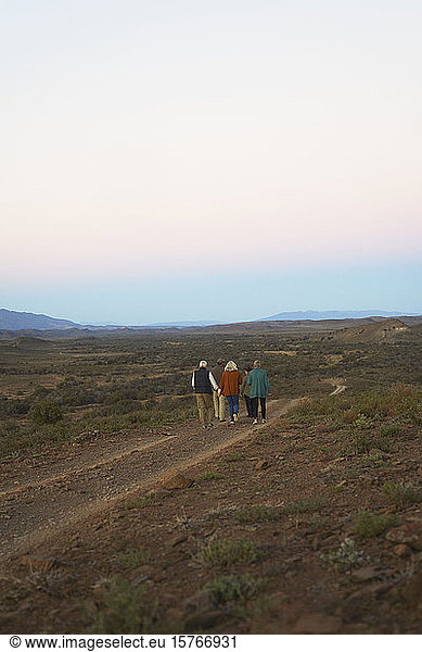 Safari tour group walking along dirt road on remote wildlife reserve