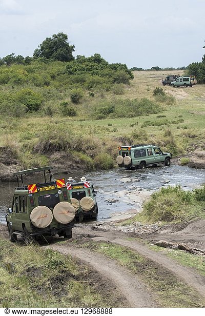 Safari vehicle crossing a stream in the Masai Mara National Reserve in Kenya.