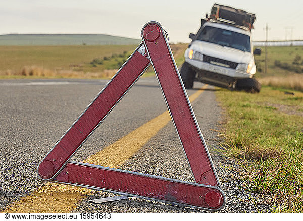 Safety triangle warning of a car accident on the side of the road  South Africa