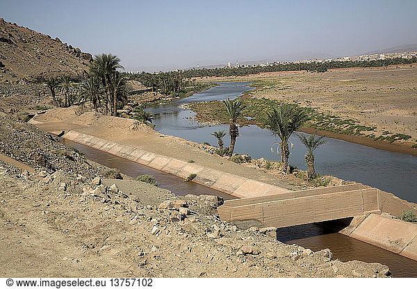 Sahara desert Zagora  Morocco Irrigation channel of canalized river  Sahara desert Zagora  Morocco  north Africa