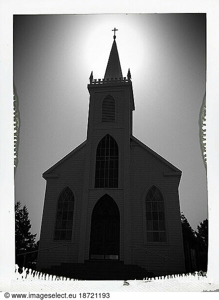Saint Teresa of Avila Roman Catholic church with the steeple backlit by the morning sun – Bodega California