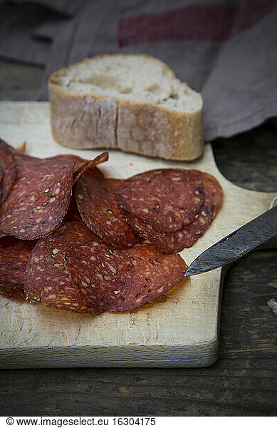 Salami in sliced on wooden table