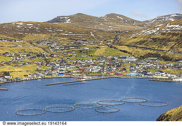 Salmon fish farm with townscape and mountains in Vestmanna  Faroe Islands