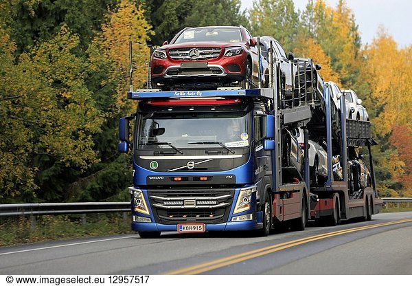 Salo  Finland - October 13  2018: Blue Volvo FM car carrier of KaWa Auto Oy hauls new Mercedes-Benz vehicles on highway on day of autumn in Finland.