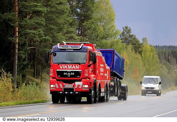 Salo  Finland. September 28  2018: Gravel transport trailer being towed by MAN heavy duty tow truck of Hinauspalvelu Vikman along highway on a rainy day.