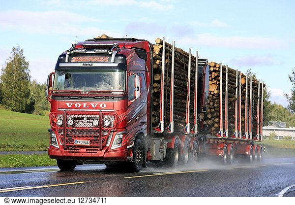 SALO  FINLAND - SEPTEMBER 22  2018: Red Volvo FH16 750 logging truck of Kuljetusliike Seppo Saarinen transports log load on wet road in autumn.