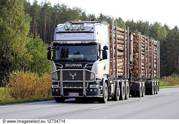 SALO  FINLAND - SEPTEMBER 21  2018: Scania logging truck of Mauri Virtanen Oy transports load of pine logs on autumnal highway in South of Finland.