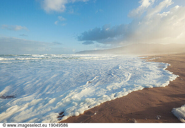 Sand beach of Atlantic ocean at summer sunny morning.