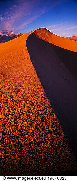 Sand Dunes of Death Valley National Park  California glow red from the setting sunset in the winter 2010.