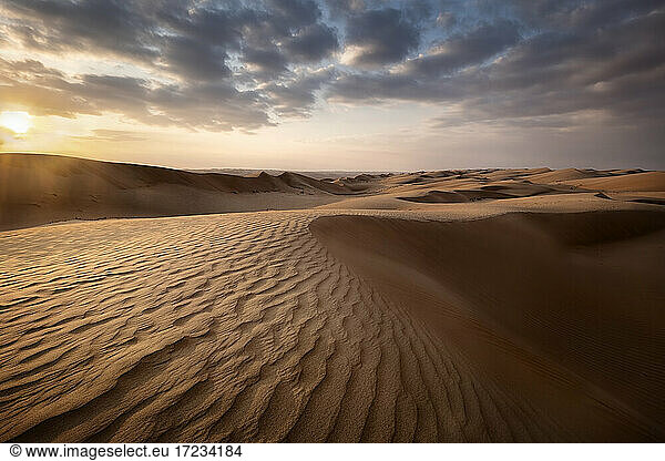 Sanddünen bei Sonnenuntergang in der Wüste Wahiba Sands mit Wolken am Himmel  Oman  Naher Osten