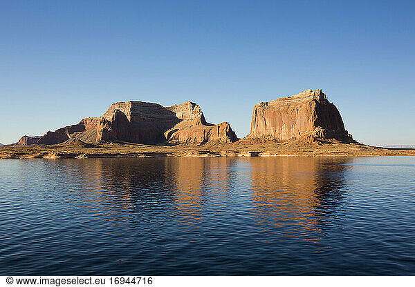 Sandstone cliffs reflected in the tranquil waters of Lake Powell  Glen Canyon National Recreation Area  Utah  United States of America  North America