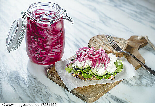 Sandwich with pickled onions  cucumbers  creamed goat cheese and lettuce