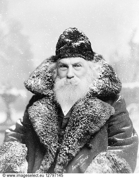 SANTA CLAUS,  c1895. A man dressed as Santa Claus in a snowy scene. Photograph,  c1895.