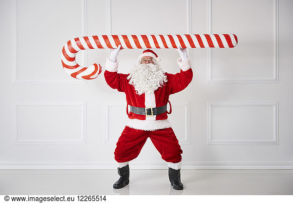 Santa Claus with oversized candy cane