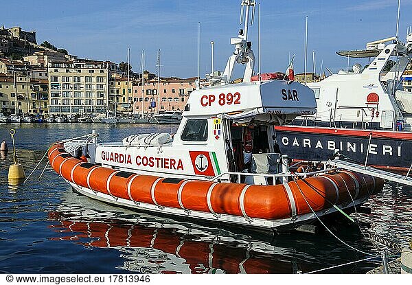SAR Search and Rescue speedboat of the Italian Coast Guard Guardia Costiera in the harbour of Portoferraio moored at the quay  behind it speedboat with Carabinieri lettering  Portoferraio  Elba  Tuscany  Italy  Europe