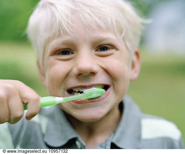 Scandinavian boy brushing his teeth  Sweden.