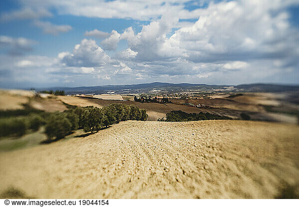 Scenic mountainside view of farmland on a sunny day in Tuscany  Italy
