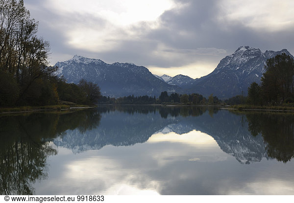 Scenic of Lake with Mountain Range in Autumn  Lake Forggensee  Fuessen  Bavaria  Germany
