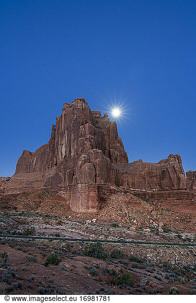 Scenic rock formation with Moon at La Sal Mountains Viewpoint at dawn  Arches National Park  Utah  USA